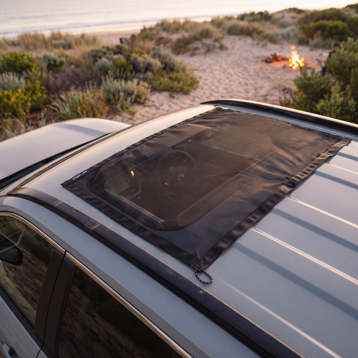 Magnetic Sunroof Mesh Screen – in use at a beachside campground at twilight