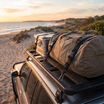 Adjustable Bungee Tie-Down Strap with Clip Hooks – in use at a coastal beach campground at sunset