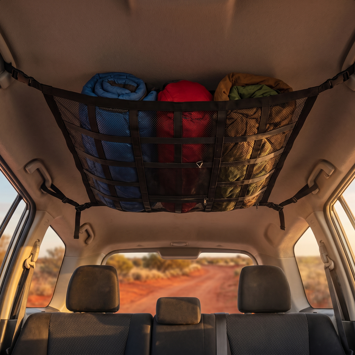 Interior Roof Cargo Net with Zip Compartment – in use at a red-dirt outback track at golden hour